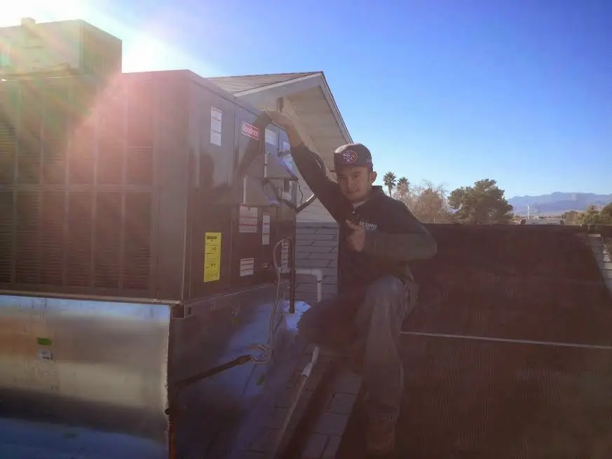 HVAC technician performing HVAC Inspection on a rooftop unit in Fort Rucker